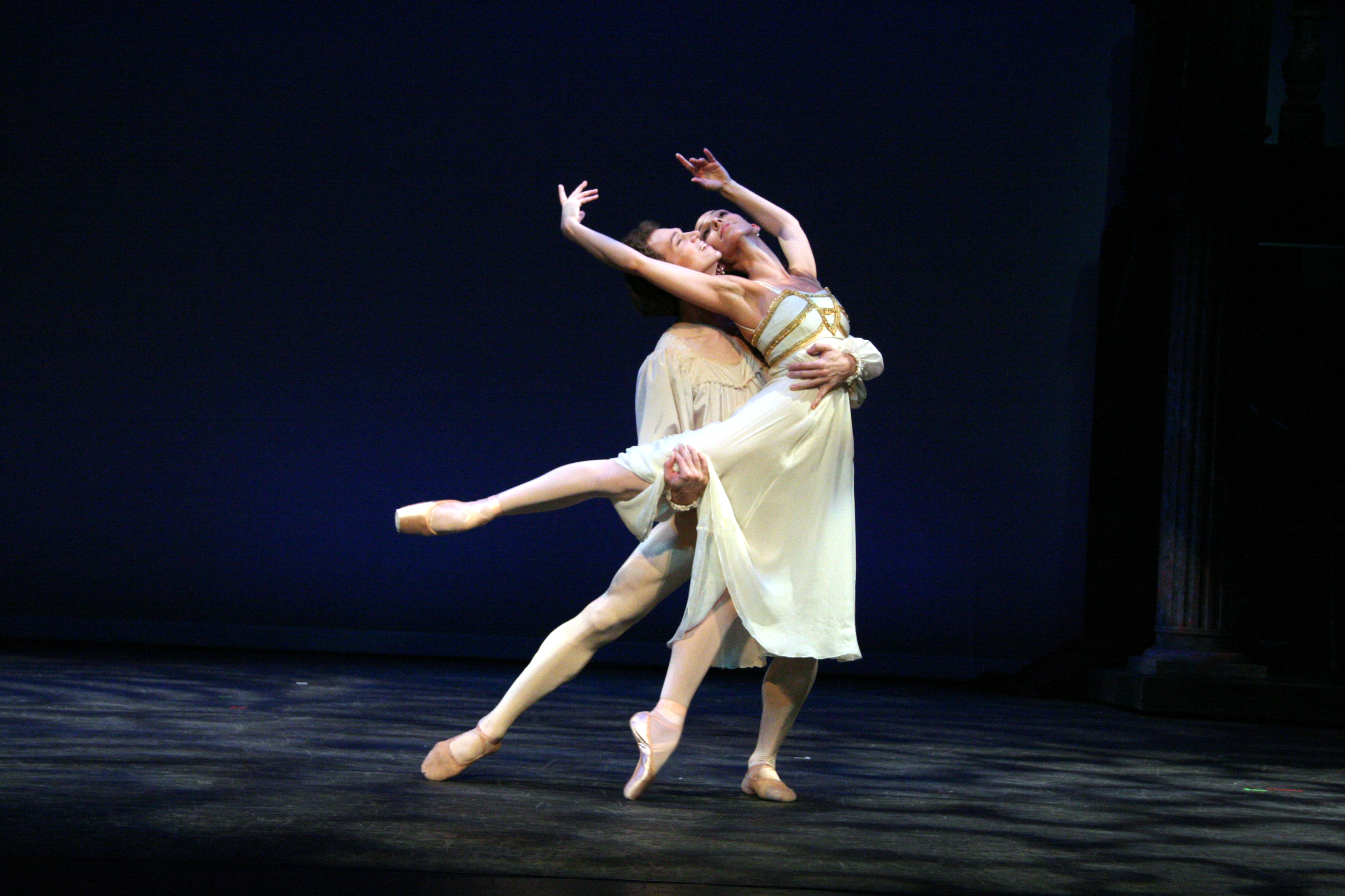 Ana two dancers on stage in white and gold